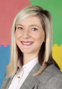 Portrait of Zsuzsanna smiling in a professional setting