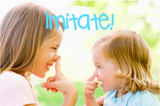 Two children imitating each other, practicing communication and social interaction