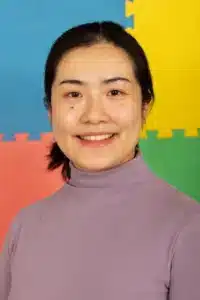 Smiling Xinru against a colorful background